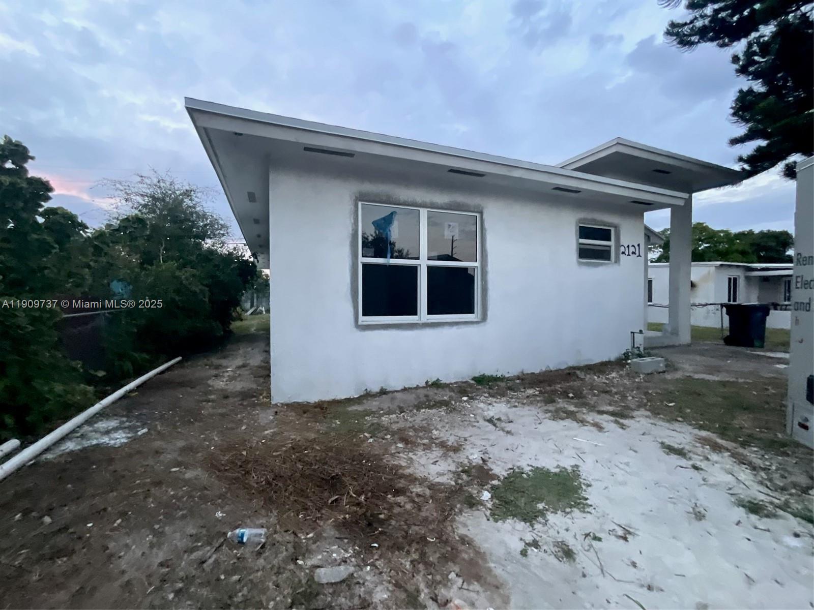 2121 Rutland Street Opa-Locka, FL 33054 - Photo 2 of 5 a front view of a house with garden