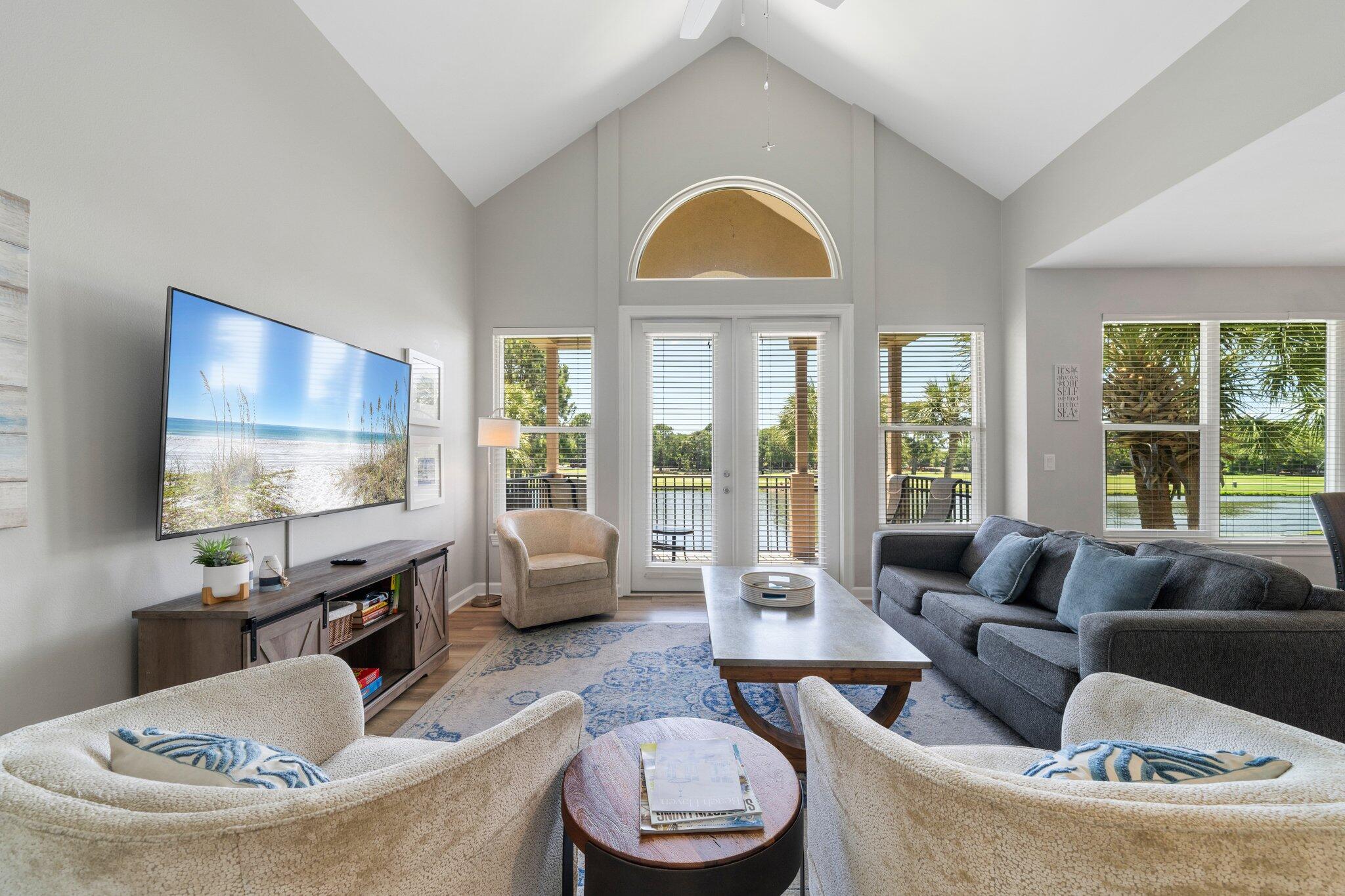 a living room with furniture a fireplace and a flat screen tv
