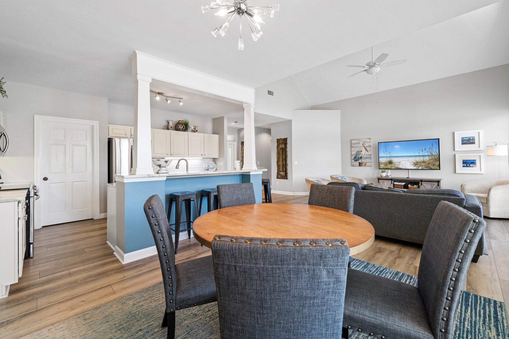 8512 Turnberry Court, Unit 8512 Miramar Beach, FL 32550 - Photo 12 of 35 a kitchen with a table chairs refrigerator and microwave