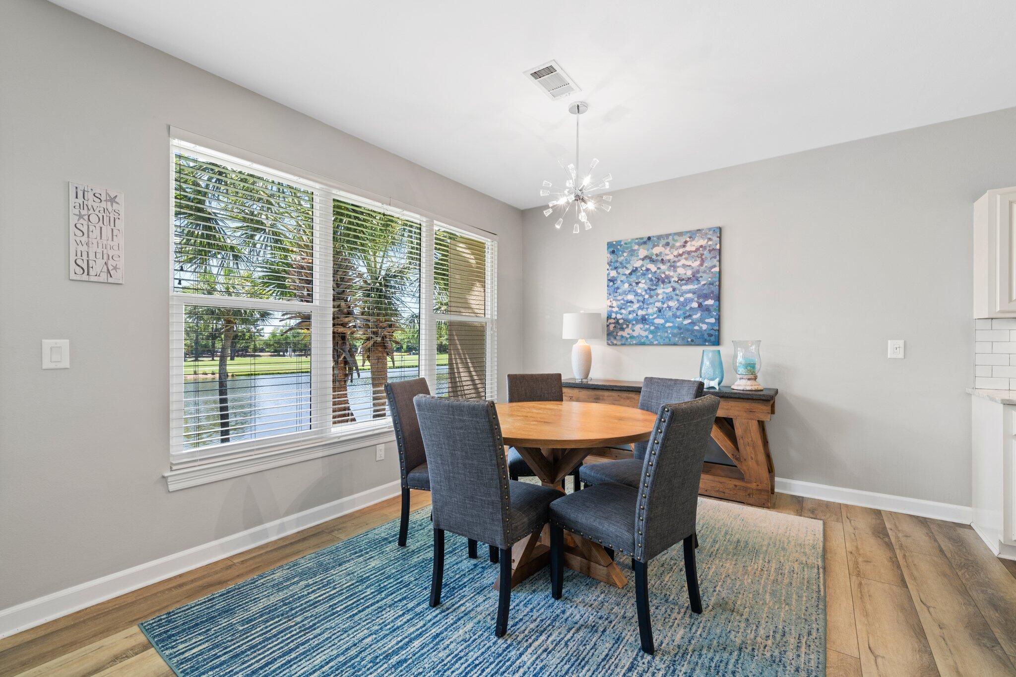 8512 Turnberry Court, Unit 8512 Miramar Beach, FL 32550 - Photo 13 of 35 a view of a dining room with furniture window and wooden floor