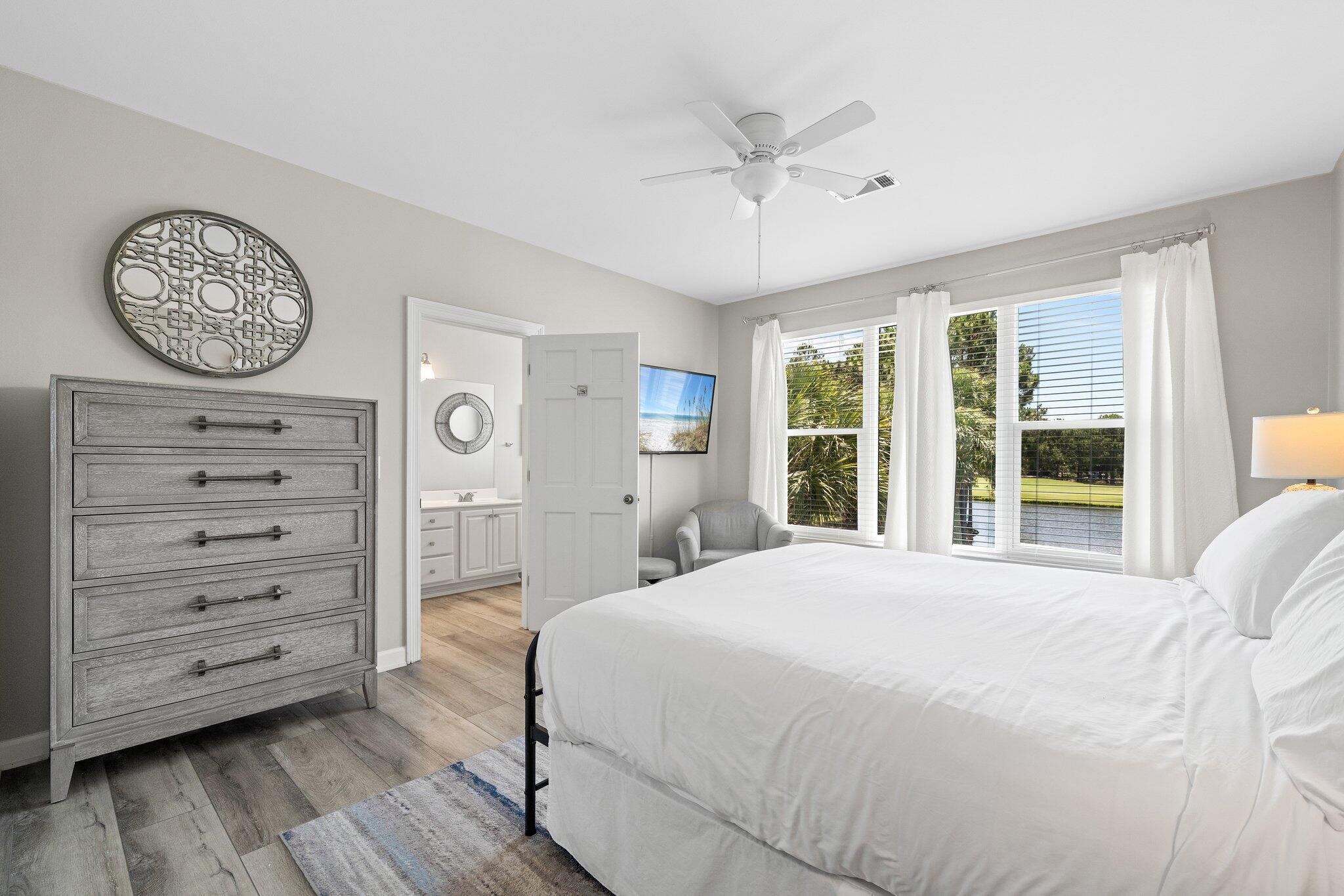 8512 Turnberry Court, Unit 8512 Miramar Beach, FL 32550 - Photo 24 of 35 a bedroom with a bed a mirror on the wall and a large window