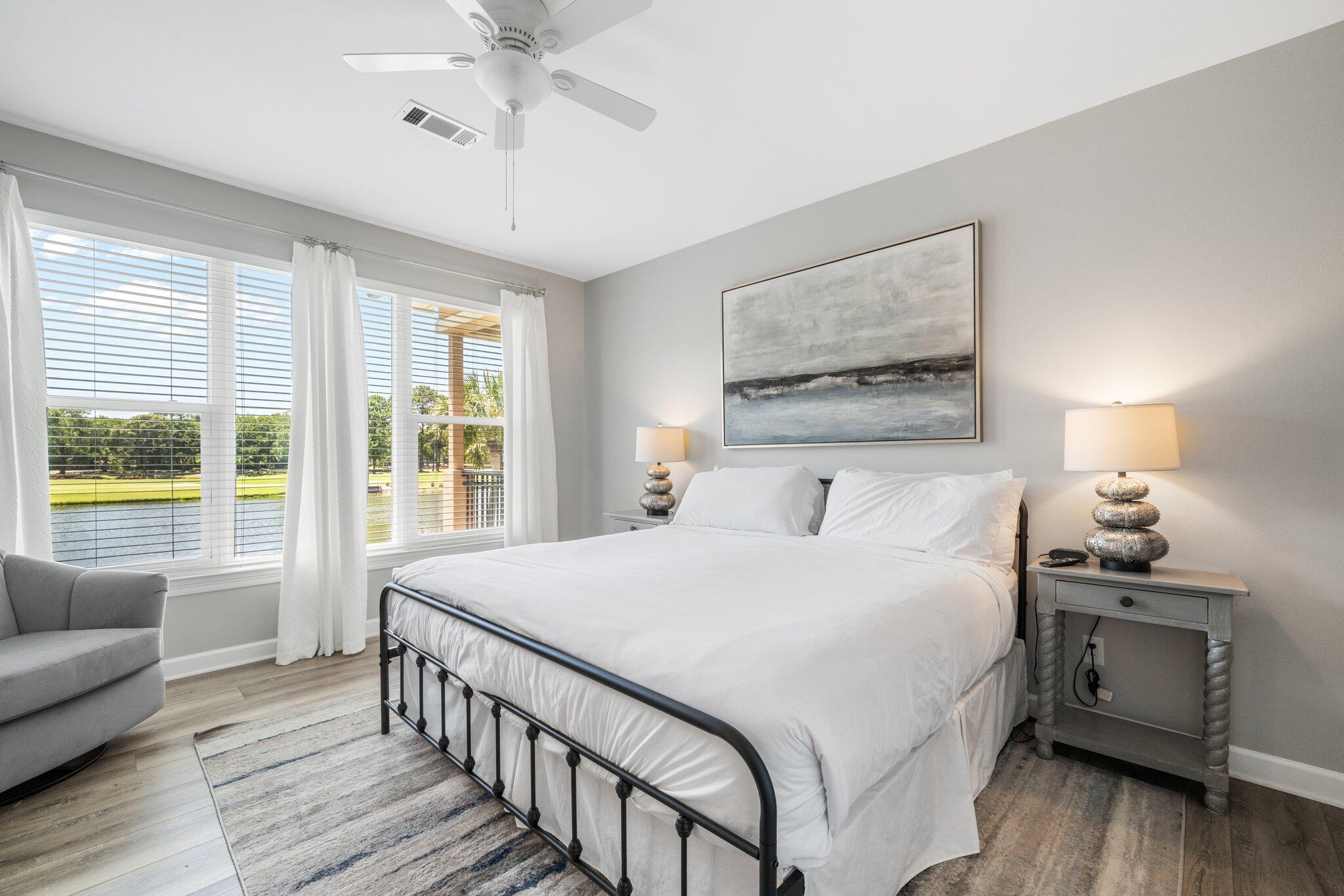 8512 Turnberry Court, Unit 8512 Miramar Beach, FL 32550 - Photo 25 of 35 a bedroom with a large bed a chandelier and windows