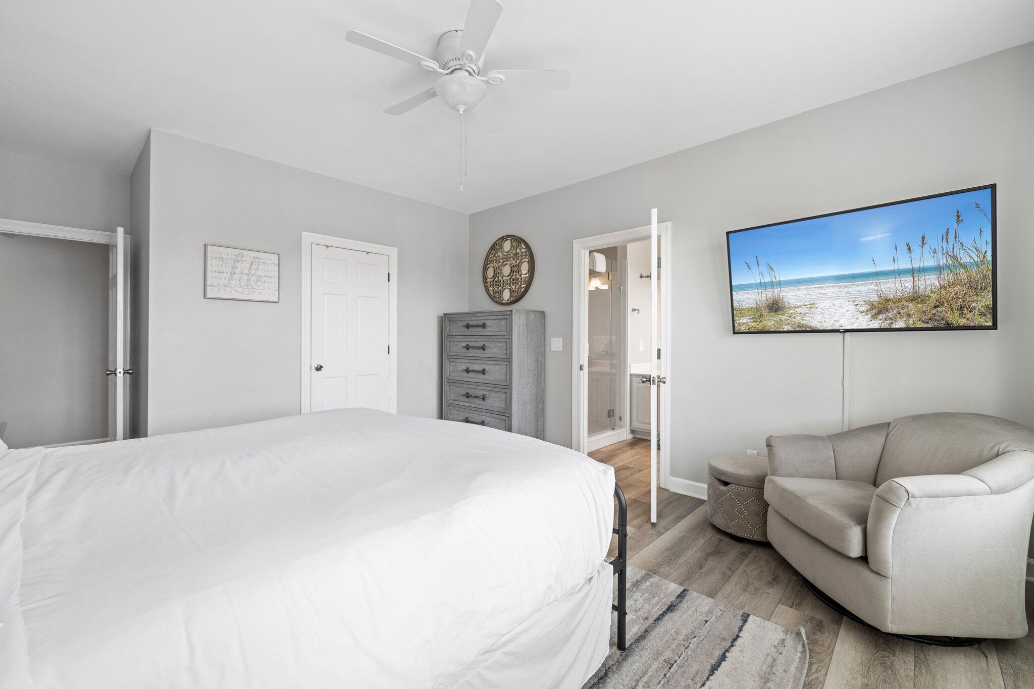 8512 Turnberry Court, Unit 8512 Miramar Beach, FL 32550 - Photo 26 of 35 a spacious bedroom with a bed and a chandelier