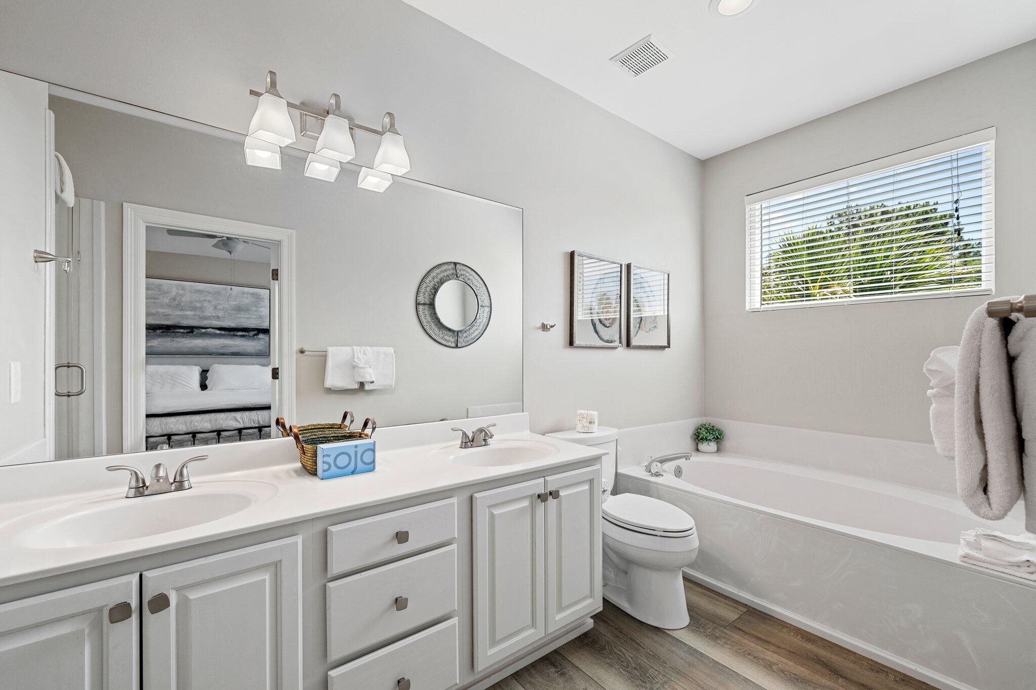 8512 Turnberry Court, Unit 8512 Miramar Beach, FL 32550 - Photo 27 of 35 a bathroom with a toilet a sink a mirror a bathtub and vanity