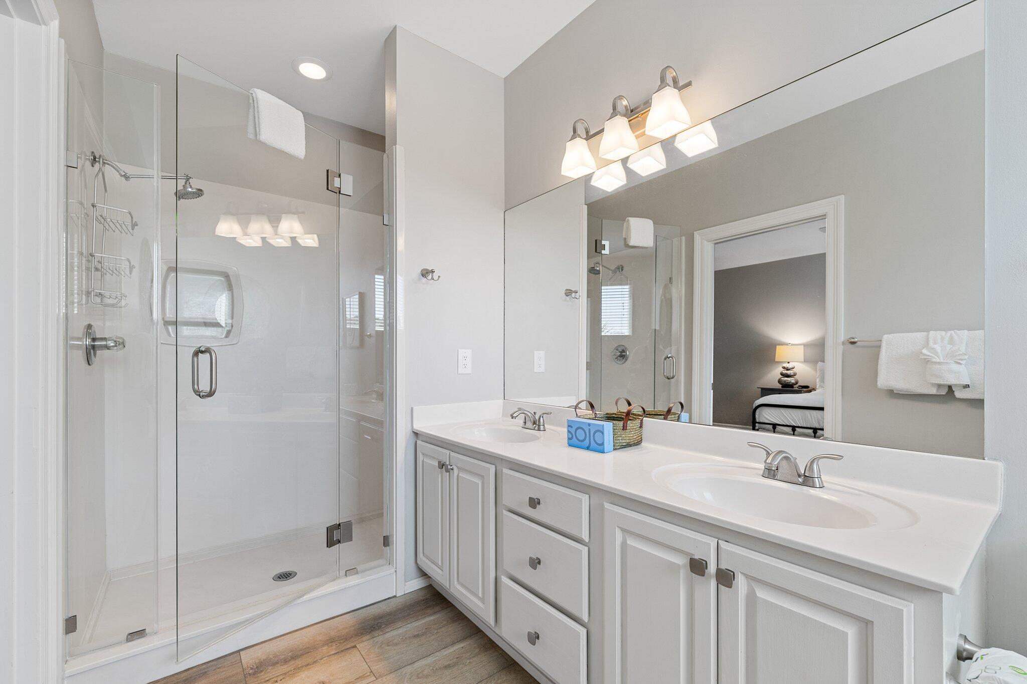 8512 Turnberry Court, Unit 8512 Miramar Beach, FL 32550 - Photo 28 of 35 a bathroom with a double vanity sink mirror and shower