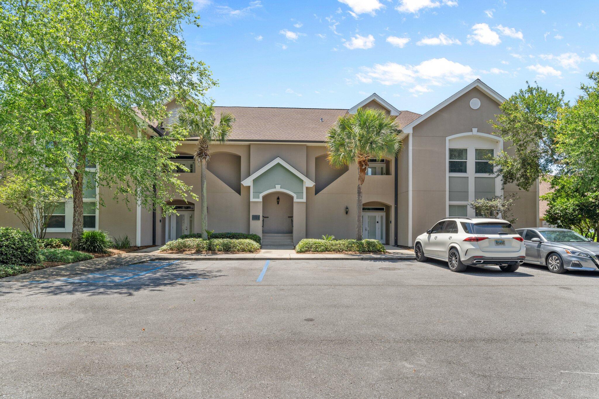 8512 Turnberry Court, Unit 8512 Miramar Beach, FL 32550 - Photo 3 of 35 a front view of a house with a garden and parking