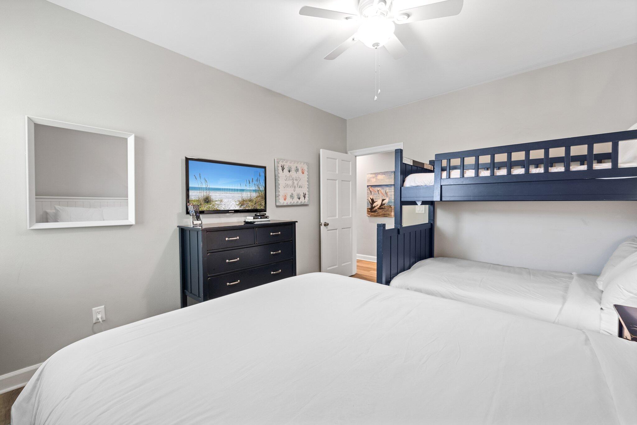 8512 Turnberry Court, Unit 8512 Miramar Beach, FL 32550 - Photo 31 of 35 a bedroom with a large bed and a flat tv screen on dresser