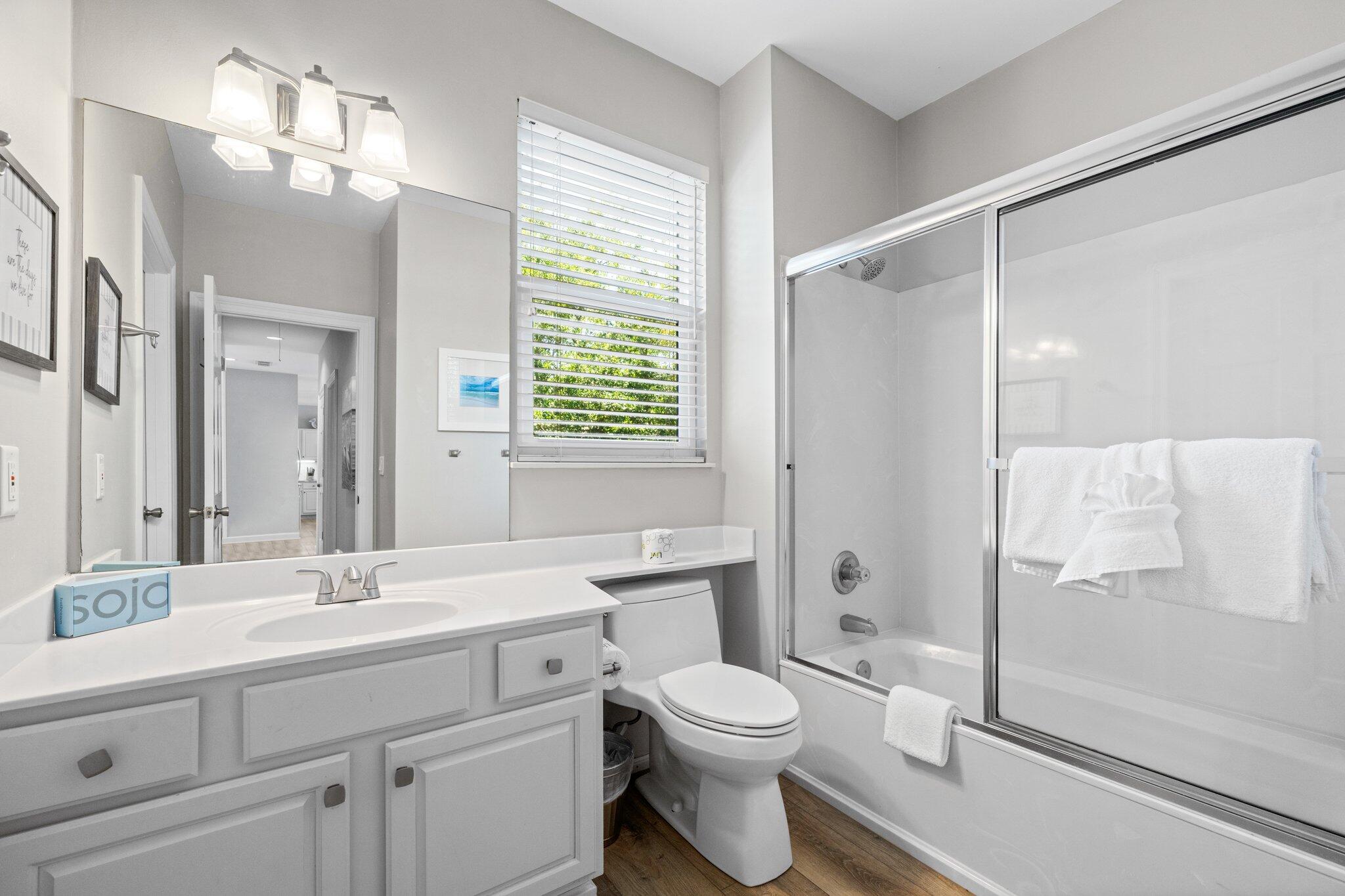 8512 Turnberry Court, Unit 8512 Miramar Beach, FL 32550 - Photo 34 of 35 a bathroom with a toilet a sink a mirror a shower a vanity and window