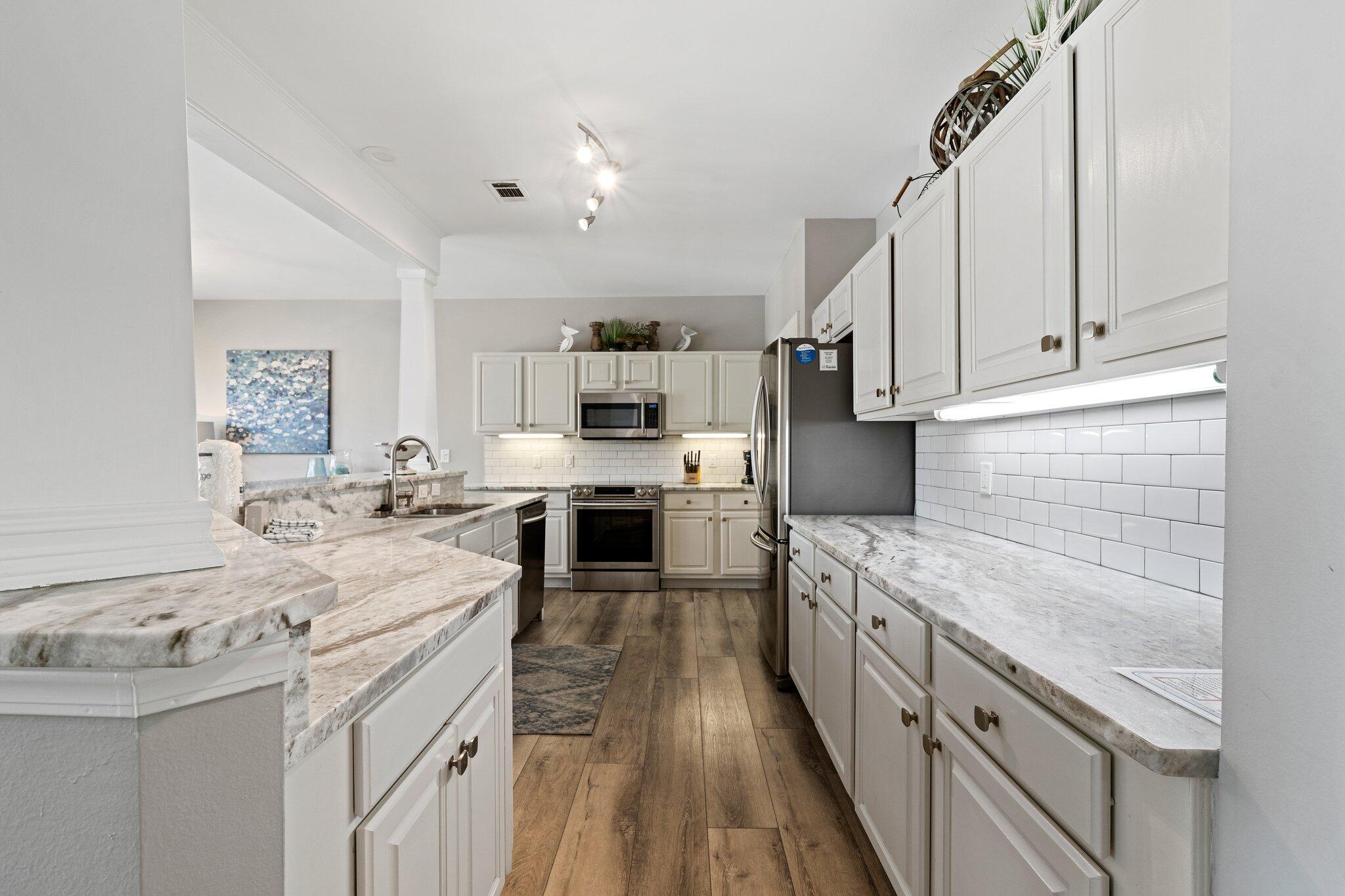 8512 Turnberry Court, Unit 8512 Miramar Beach, FL 32550 - Photo 7 of 35 a kitchen with a sink stove and cabinets