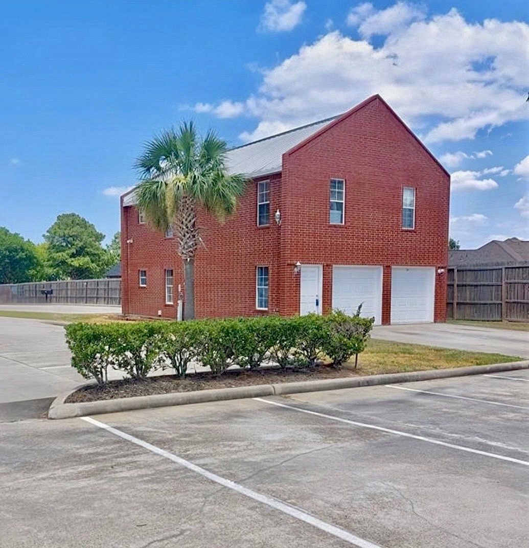 90 Beach Walk Boulevard Conroe, TX 77304 - Photo 2 of 26 a front view of a house with a garden and plants