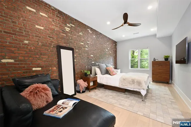 a bedroom with a bed and a painting on the wall