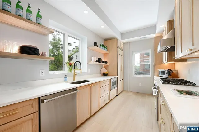 a kitchen with a sink stove and cabinets