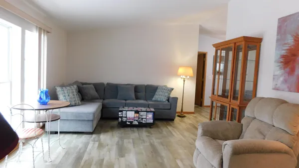 a living room with furniture and a lamp