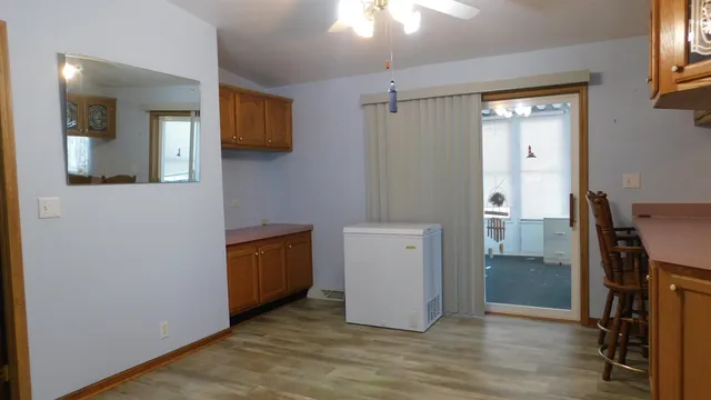 a view of a hallway with closet and wooden floor