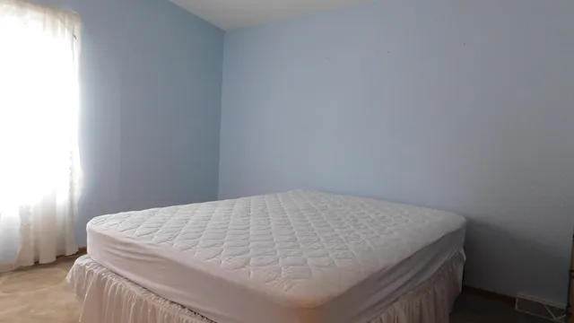 a bedroom with a bed and a wall painting