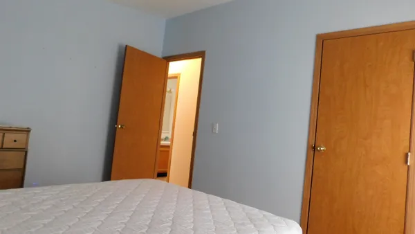 a bedroom with a bed and a wall painting