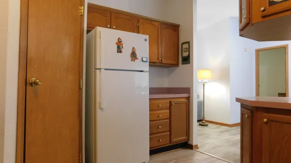 a view of kitchen with a refrigerator