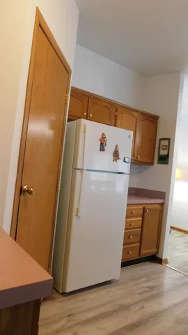 a view of a kitchen with stainless steel appliances granite countertop a stove and a refrigerator