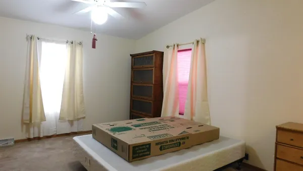 a view of a hallway with closet and wooden floor