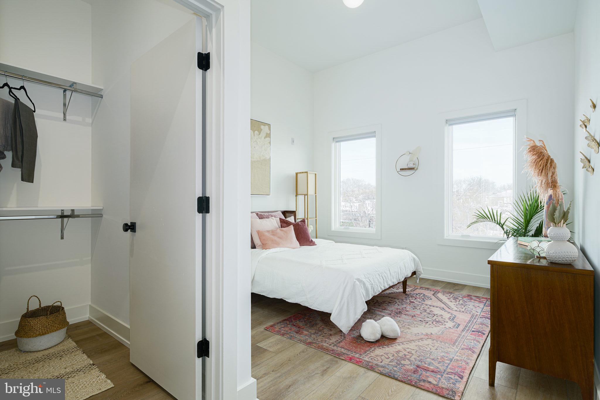 5013 Springfield Avenue, Unit 510 Philadelphia, PA 19143 - Photo 8 of 16 a bedroom with a bed and a potted plant