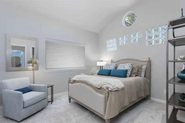 a bedroom with a bed couch and window