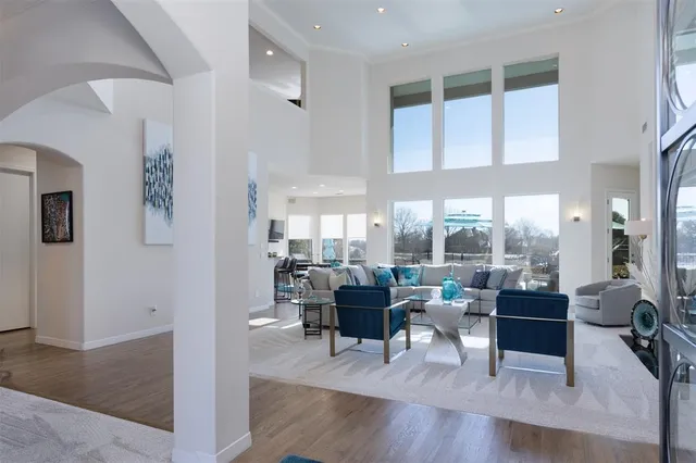 a living room with furniture and large windows
