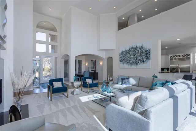 a living room with furniture and a chandelier