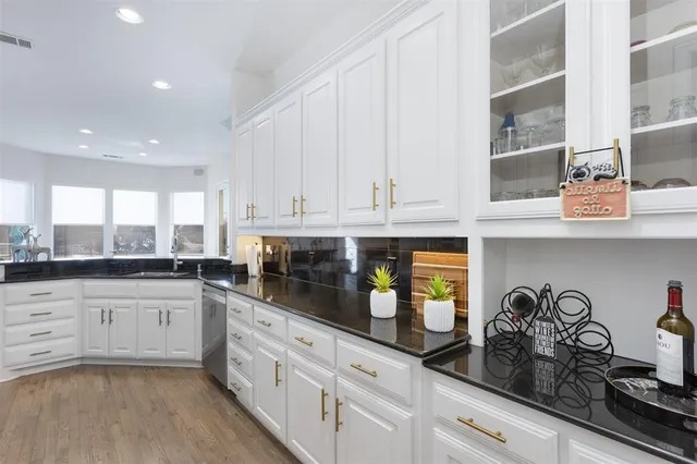 a kitchen with white cabinets and appliances
