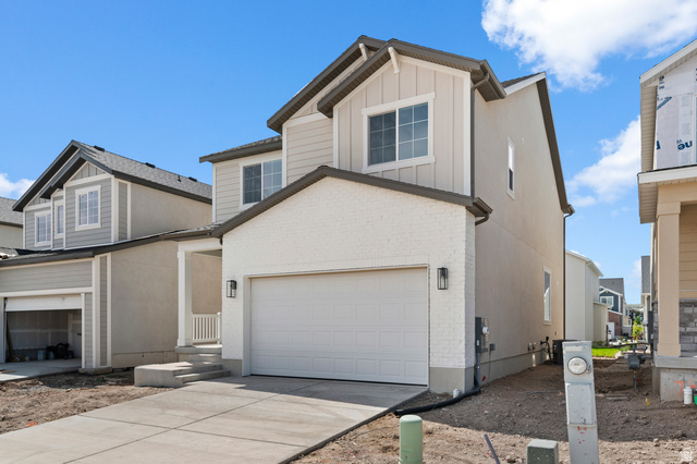 7797 West Alta Springs Way Magna, UT 84044 - Photo 2 of 21 View of front of home featuring brick siding, board and batten siding, and driveway