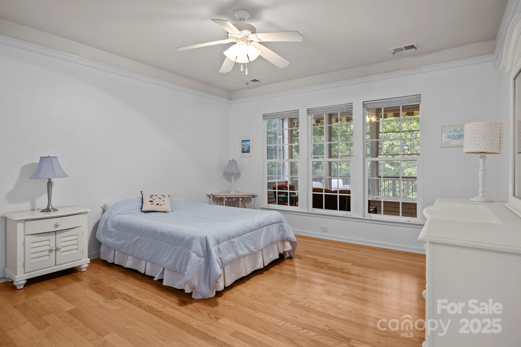 17517 Hawks View Drive, Unit 164 Fort Mill, SC 29707 - Photo 18 of 39 a bedroom with a large bed and a large window