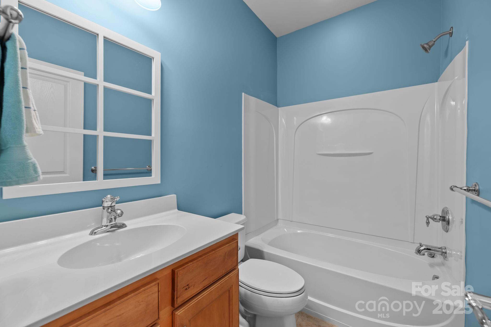 17517 Hawks View Drive, Unit 164 Fort Mill, SC 29707 - Photo 24 of 39 a bathroom with a sink toilet vanity and shower