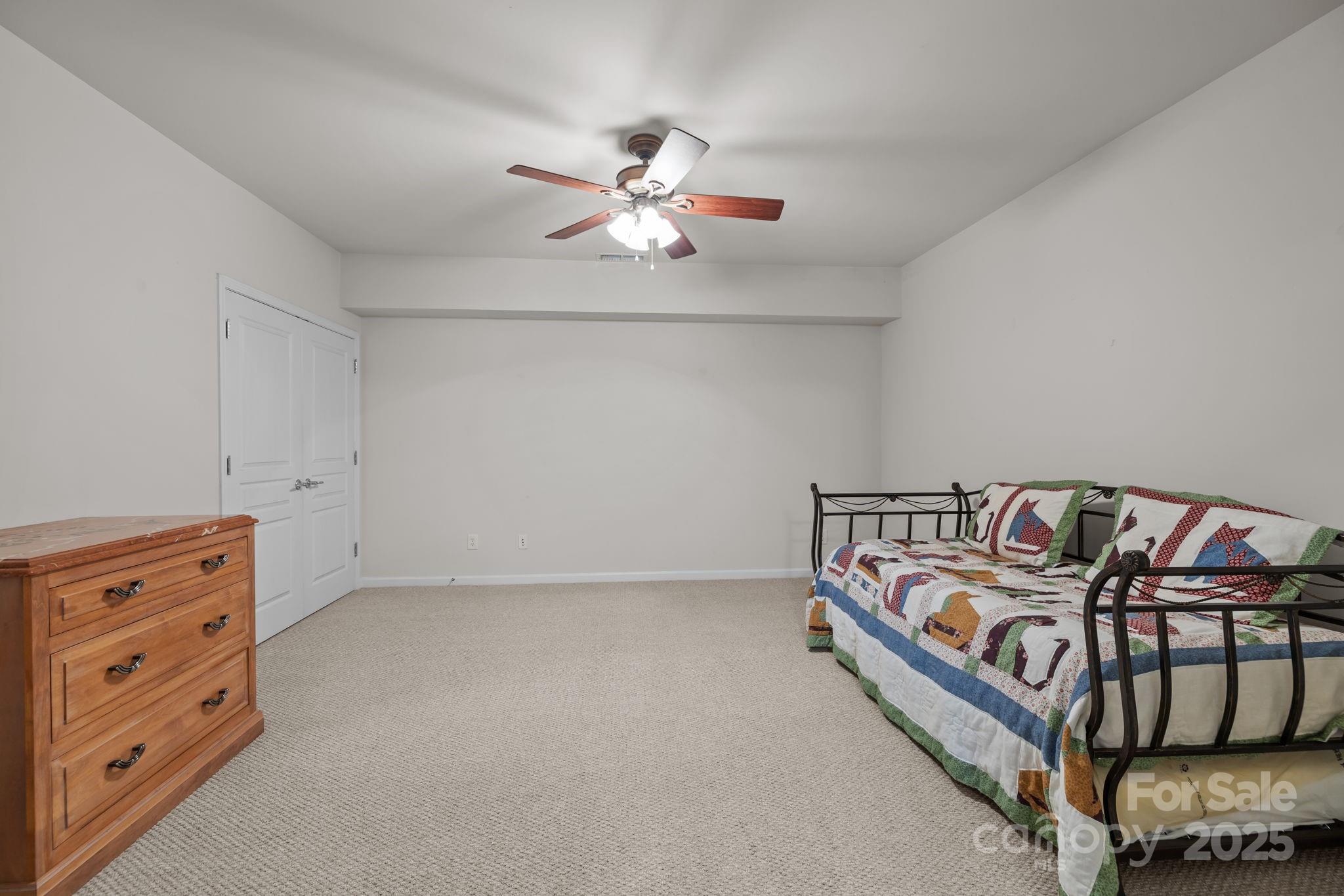 17517 Hawks View Drive, Unit 164 Fort Mill, SC 29707 - Photo 31 of 39 a bedroom with a bed and a chandelier