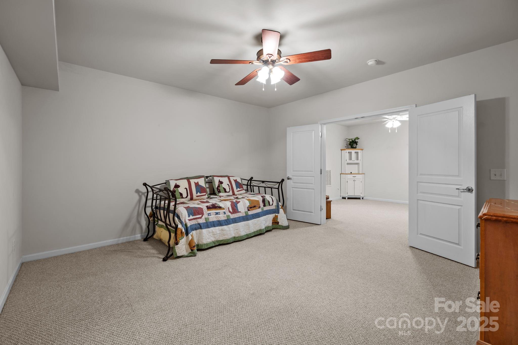 17517 Hawks View Drive, Unit 164 Fort Mill, SC 29707 - Photo 32 of 39 a spacious bedroom with a bed and a ceiling fan