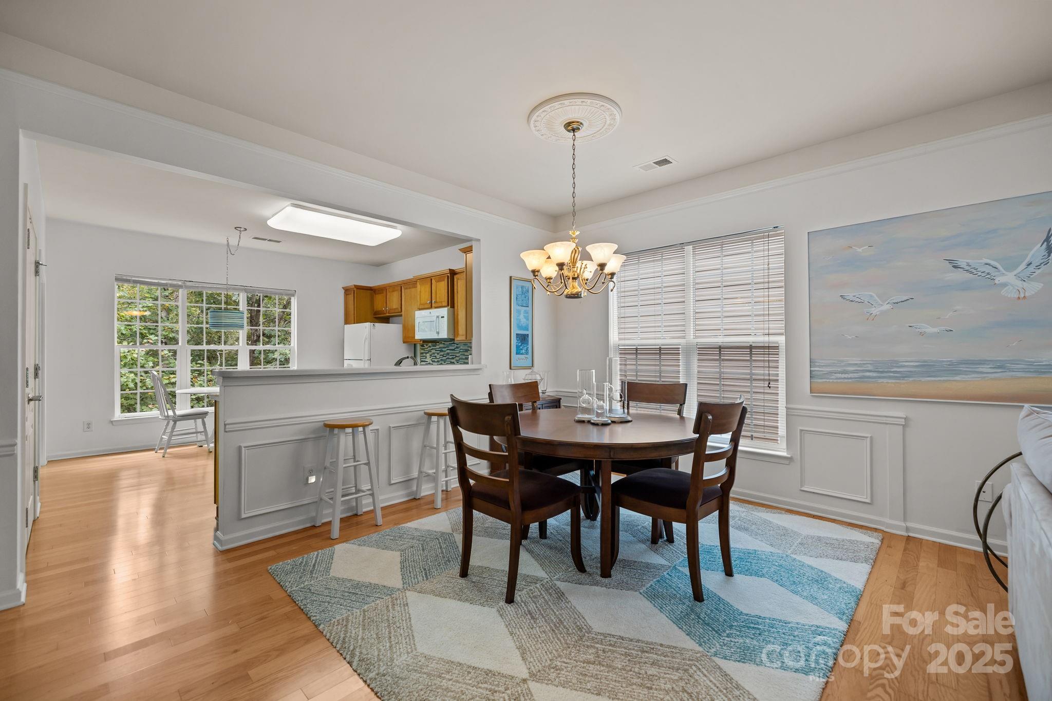 17517 Hawks View Drive, Unit 164 Fort Mill, SC 29707 - Photo 8 of 39 a view of a dining room with furniture window and wooden floor