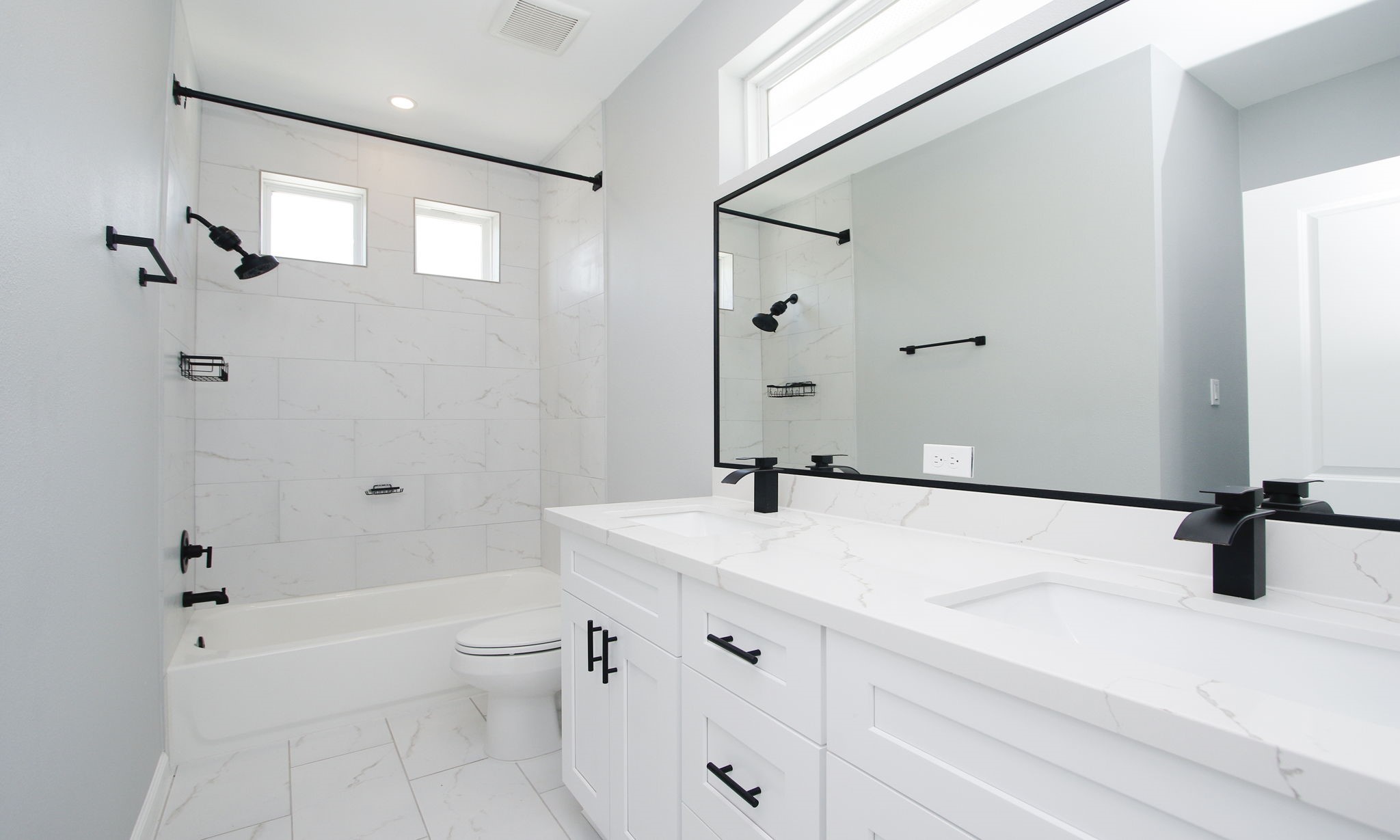 4337 Faulkner Street Houston, TX 77021 - Photo 27 of 39 a bathroom with a sink a toilet and a large mirror
