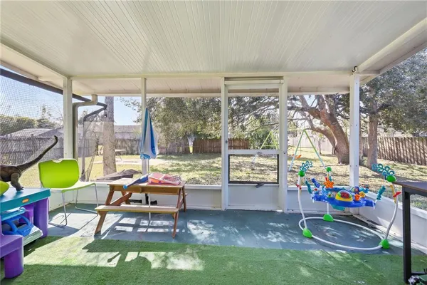 a room with pool table and chairs
