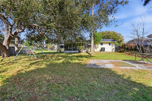 a view of a yard with swimming pool