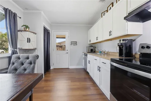 a kitchen with wooden cabinets and center island