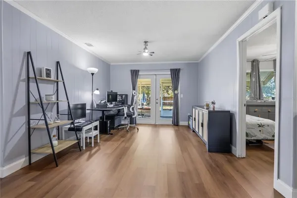 a living room with furniture and a wooden floor