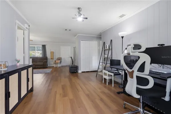 a view of a room with wooden floor and windows