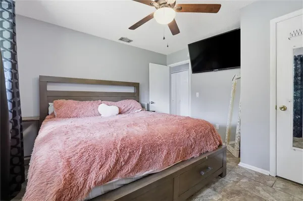 a bedroom with a bed and a flat screen tv
