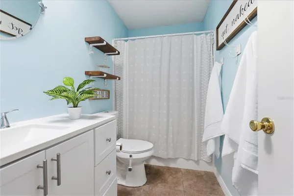 a bathroom with a sink a toilet and a shower