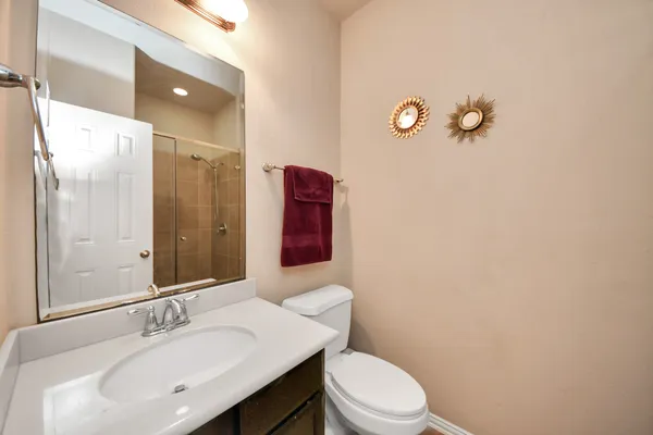 a bathroom with a toilet a sink and mirror