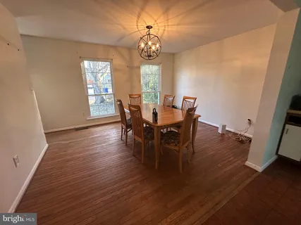 a view of a dining room with furniture and window