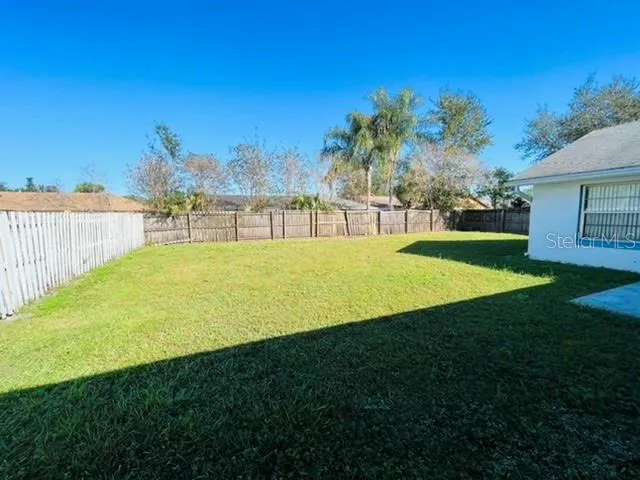 a view of a backyard with a garden and deck