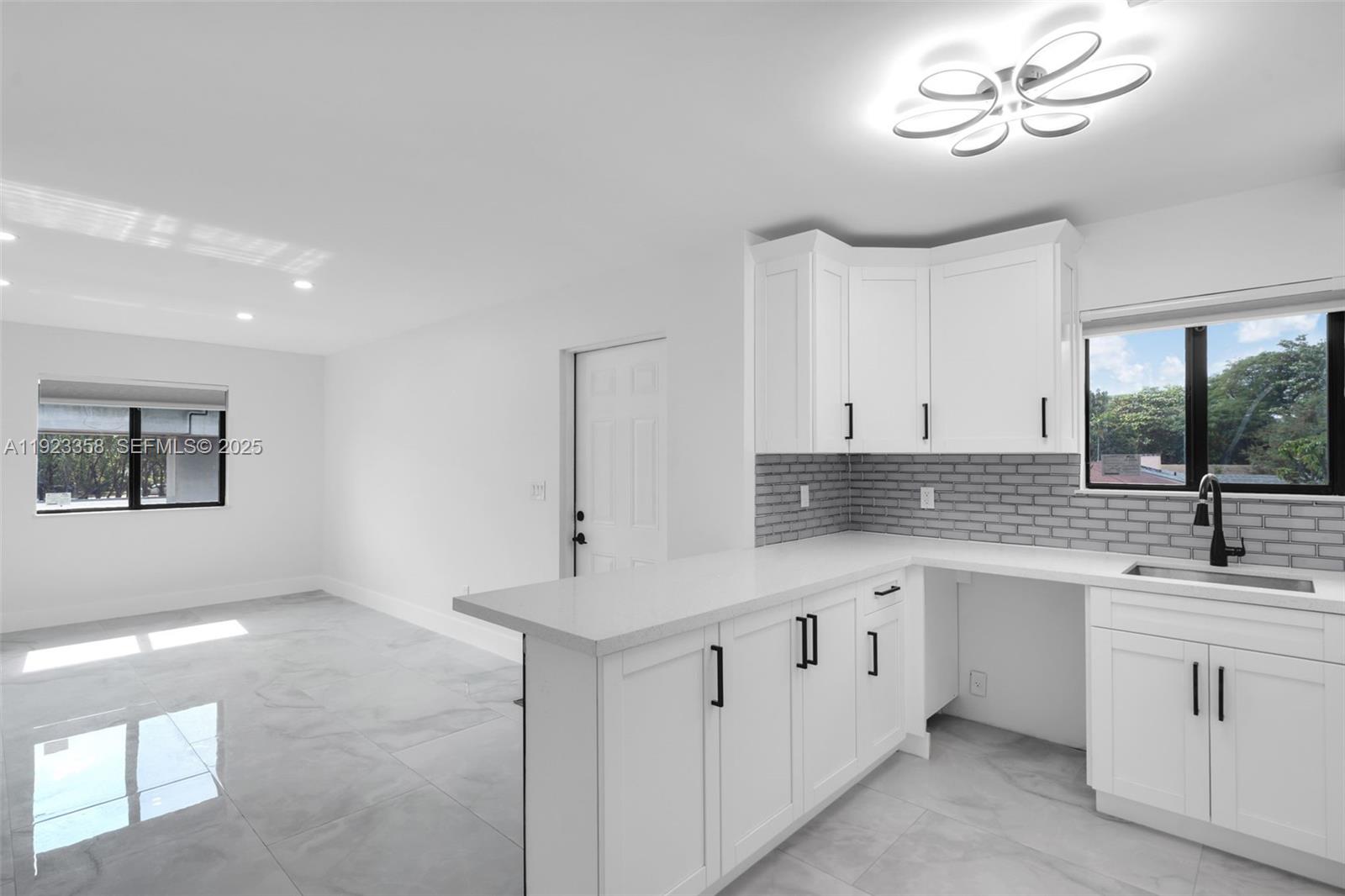 1413 Northwest 40th Street Miami, FL 33142 - Photo 11 of 30 a kitchen with a sink cabinets and window