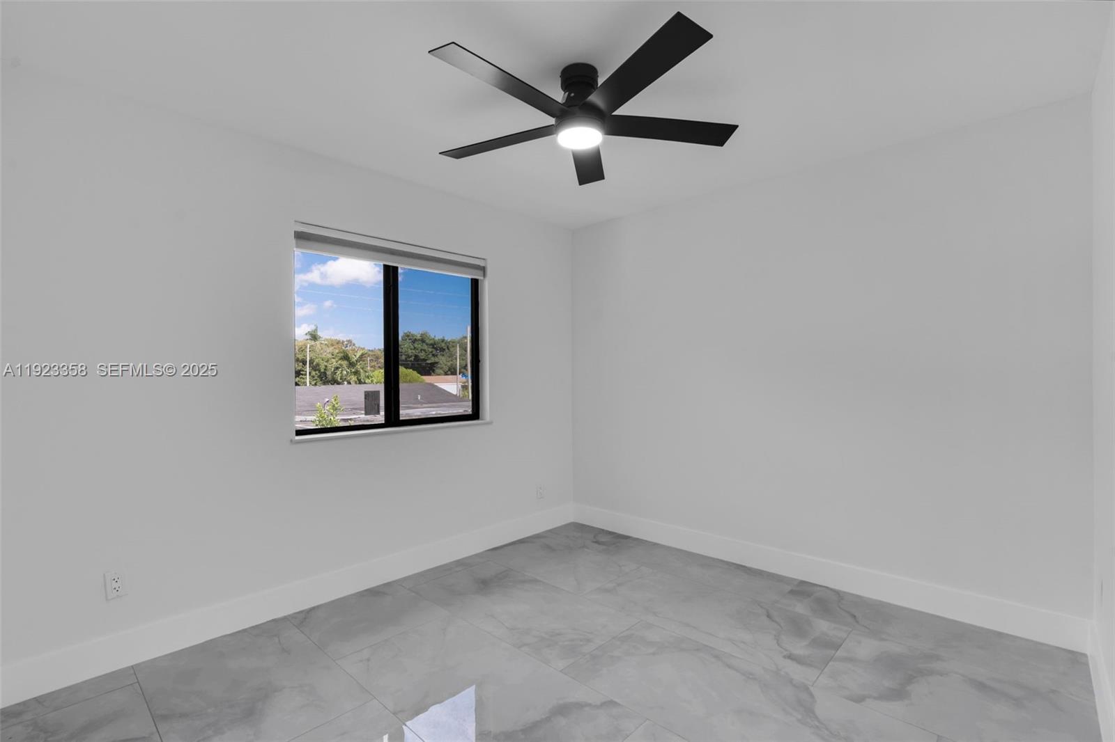 1413 Northwest 40th Street Miami, FL 33142 - Photo 17 of 30 an empty room with a window and a ceiling fan