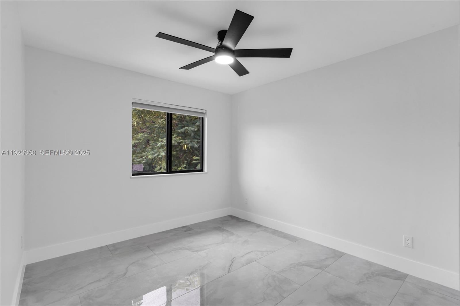 1413 Northwest 40th Street Miami, FL 33142 - Photo 19 of 30 an empty room with a window