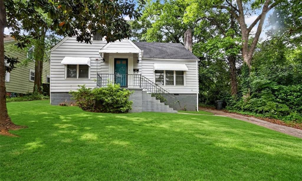 2728 Winburn Terrace Atlanta, GA 30344 - Photo 1 of 16 a front view of a house with a yard and garage