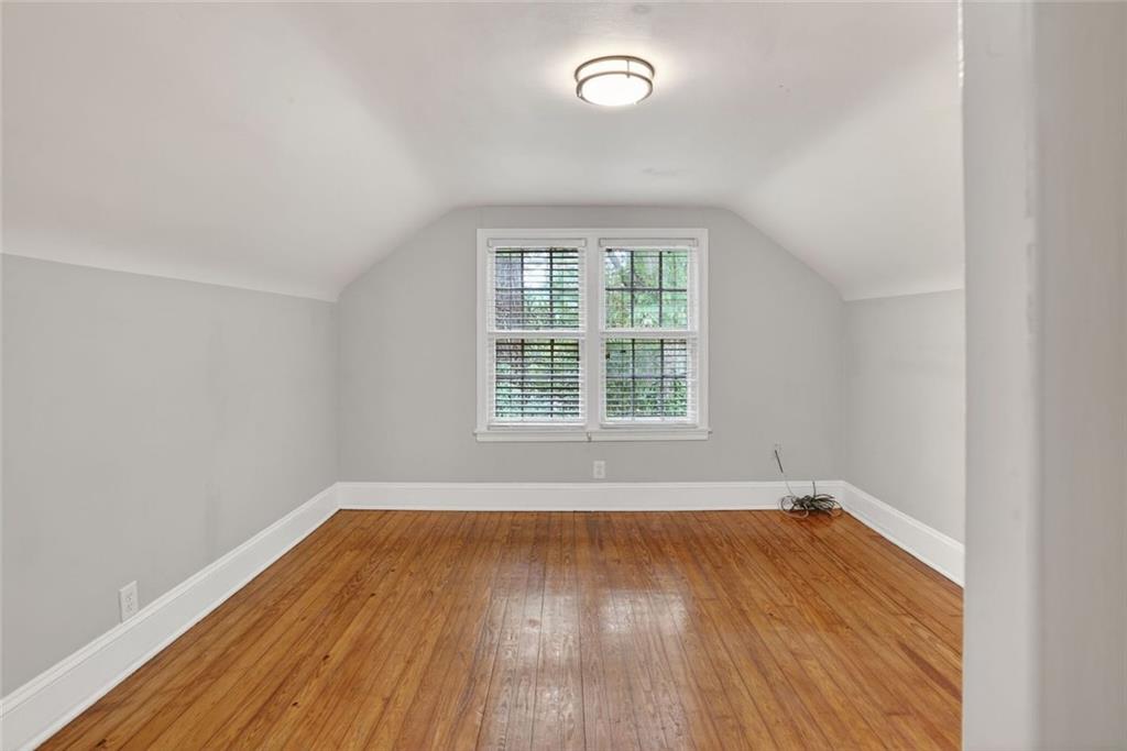 2728 Winburn Terrace Atlanta, GA 30344 - Photo 12 of 16 an empty room with wooden floor and windows